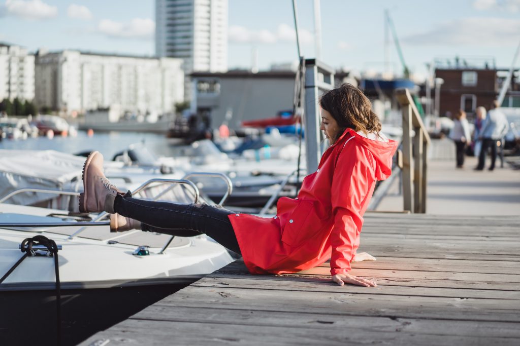 beautiful young woman red cloak yacht port stockholm sweden