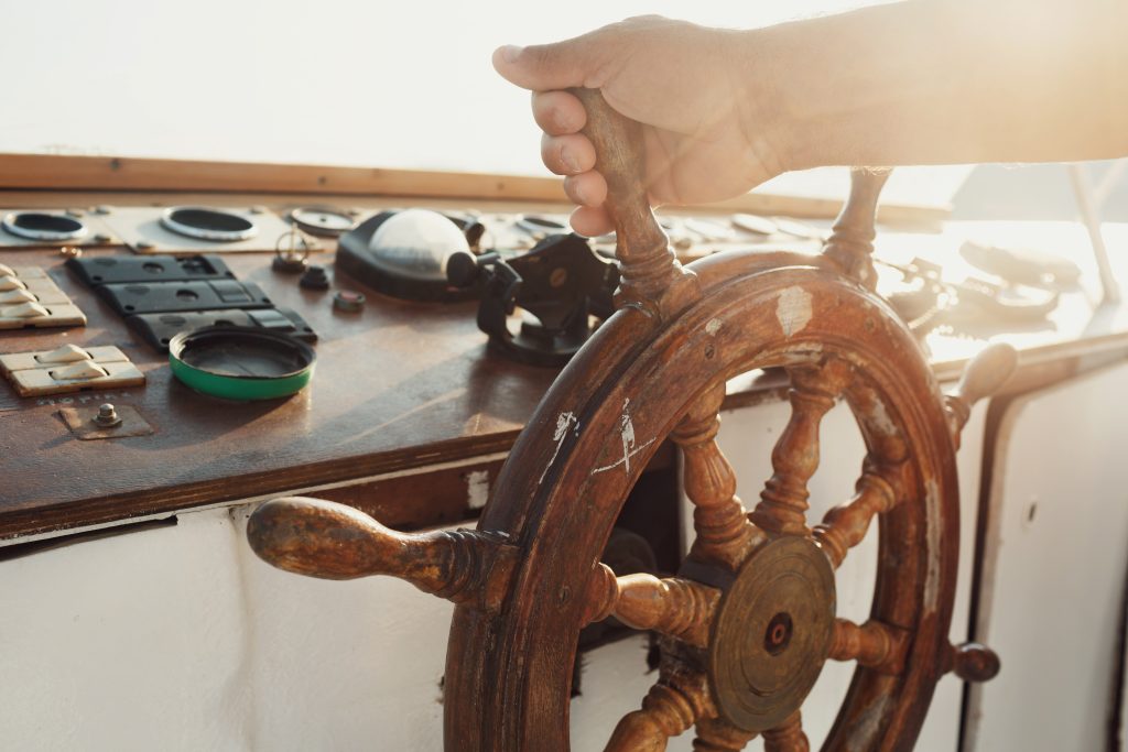 sun shines wooden wheel held by man 1